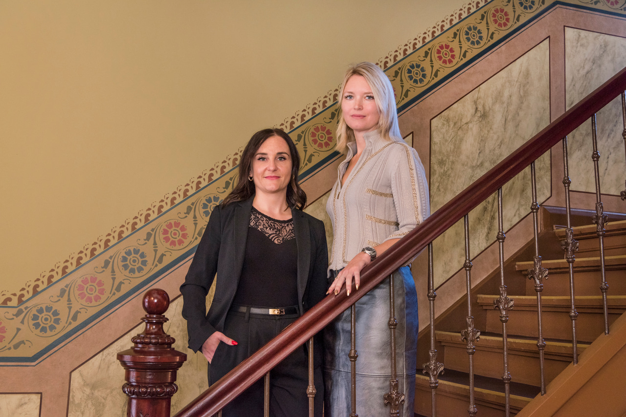 Portrait of two women together in a historic stairwell